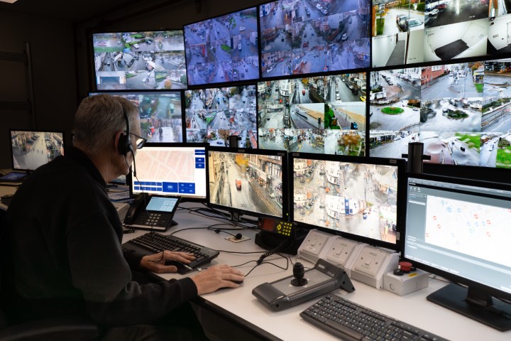 CCTV operator at a bank of screens.