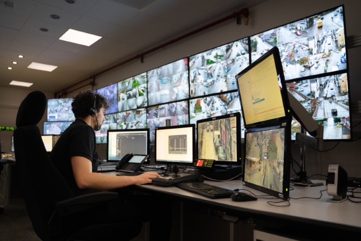 CCTV operators at a bank of monitors.